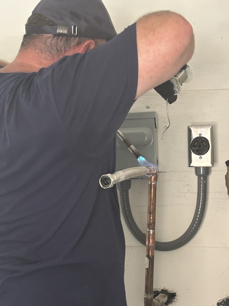 Tankless water heater flame rod before and after maintenance