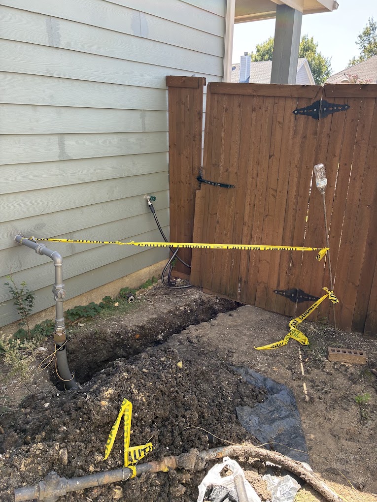 Excavated tunnel showing repaired residential water line